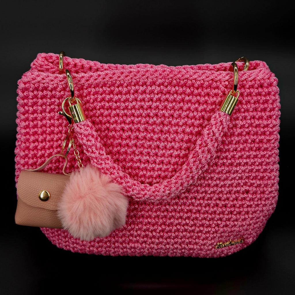 Bolso de mano crochet rosa con accesorios