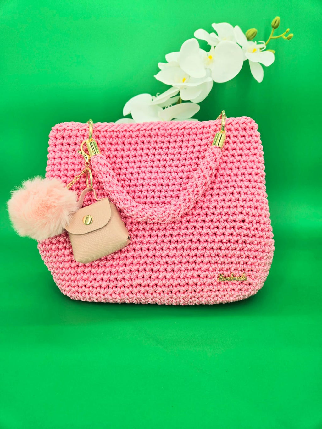 Bolso de mano crochet rosa con accesorios